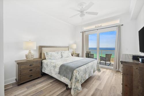 a bedroom with a bed and a view of the ocean at Laketown Wharf #2011 by Nautical Properties in Panama City Beach