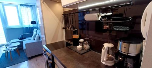 a kitchen with a counter with a coffee maker on it at Black Sails z Parkingiem in Kołobrzeg