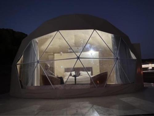 a man sitting in a room in a dome shaped building at Wadi rum Ahmed Badawi in Wadi Rum