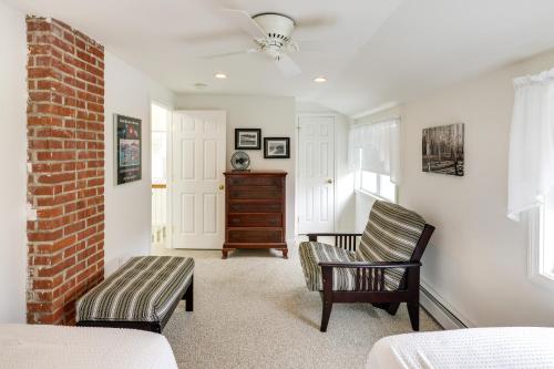 a bedroom with two chairs and a table and a brick wall at Charming Old Saybrook Home Half-Mi to Sand and Sea! in Old Saybrook
