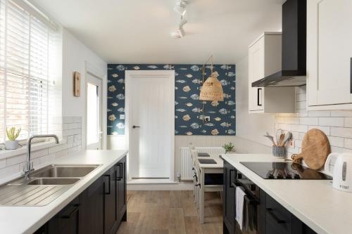 a kitchen with a sink and a counter at Low Tide @ Filey. Close to Beach. Dog Friendly. in Filey