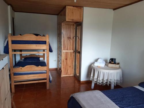 a bedroom with a bunk bed and a table at Casa Familia Rubio in Oxapampa
