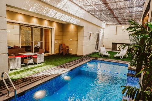 a swimming pool in the middle of a house at M Residence New Cairo - Families only in Cairo