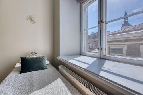 a window seat in a room with a view of a building at Historic Residence Apartments at Old Town in Tallinn