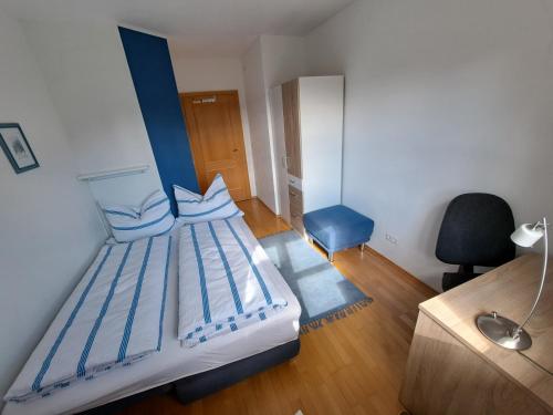 a bedroom with a bed and a desk and a chair at Appartement Pölzl Öblarn Region Schladming Dachstein in Öblarn
