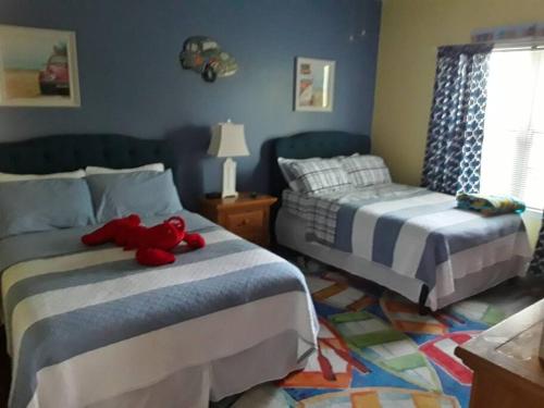a bedroom with two beds with a red teddy bear on them at Legends Golf Beachy Condo in Myrtle Beach