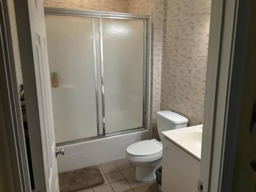 a bathroom with a shower and a toilet and a sink at Legends Golf Beachy Condo in Myrtle Beach