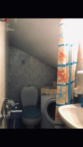a small bathroom with a toilet and a sink at The View Spot in Serifos Chora
