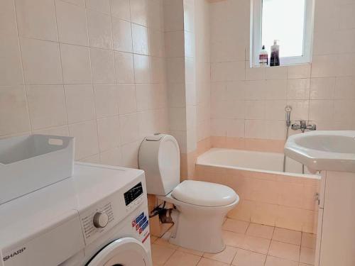 a white bathroom with a toilet and a sink at 2BR Apartment next to National Archaeological Museum and AUEB in Athens