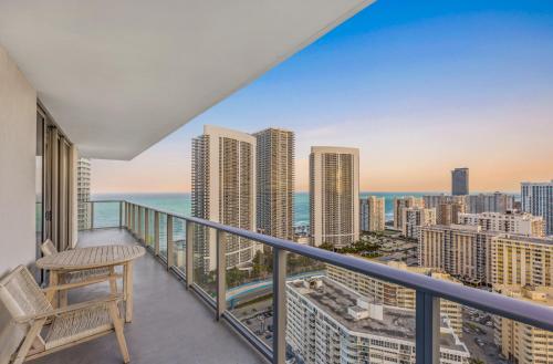 a balcony with a chair and a view of the city at Hyde House - Luxury High Floor 2BR 2BA Apartment Suite with direct ocean view, roof top pool, resort amenities in Hollywood