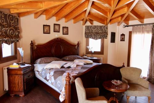 a bedroom with a large bed with a wooden frame at Villa Ariadne in Athens