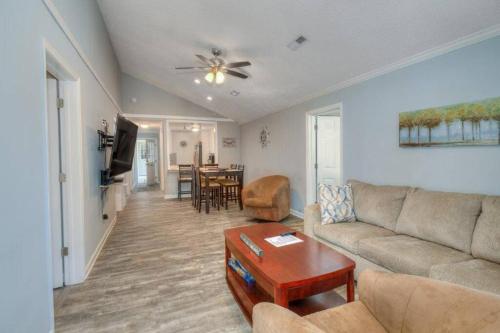 a living room with a couch and a table at Beach Lovin/sleeps 10/2 blocks to beach/pets ok in Myrtle Beach
