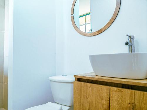 a bathroom with a sink and a mirror at The Gardens by Hope in Guatapé