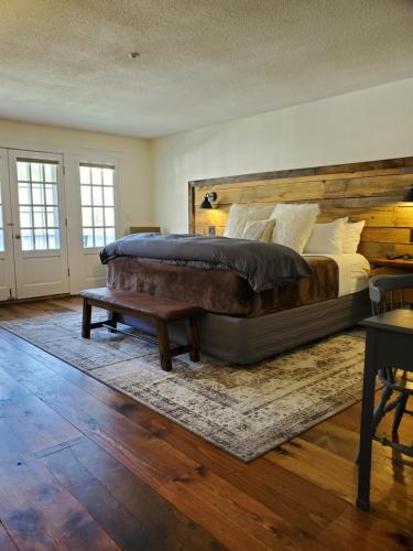 a bedroom with a large bed and a wooden headboard at Farm Road Estate in West Dover