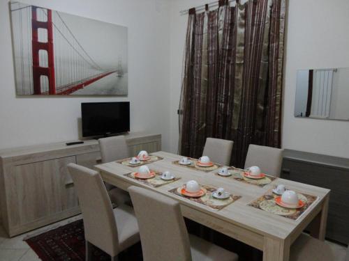a dining room with a wooden table and chairs at B&B Nola in Nola