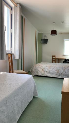 Postel nebo postele na pokoji v ubytování WEAA Hotel