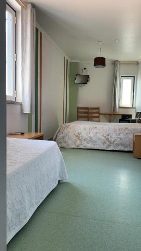 Postel nebo postele na pokoji v ubytování WEAA Hotel