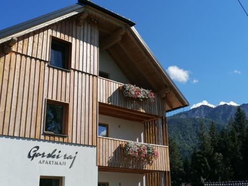 a building with flowers on the balconies of it at Apartments Gorski raj in Kranjska Gora