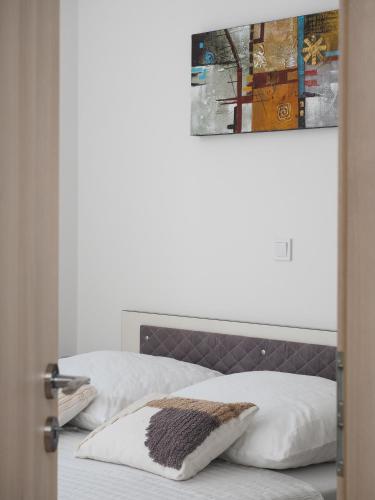 two beds with white sheets and a brown headboard at Villa Sirenis in Trogir