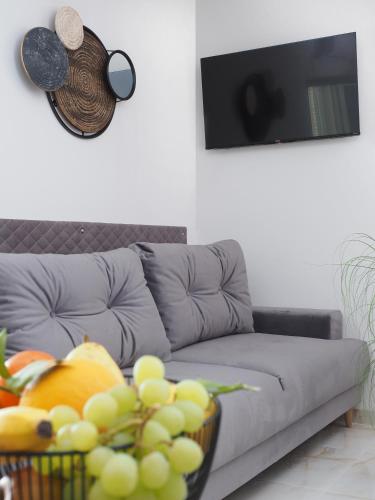 a living room with a couch with a basket of fruit at Villa Sirenis in Trogir
