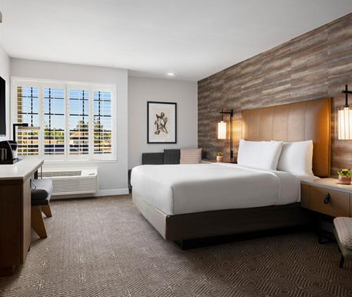 a hotel room with a large bed and a desk at Napa Winery Inn in Napa