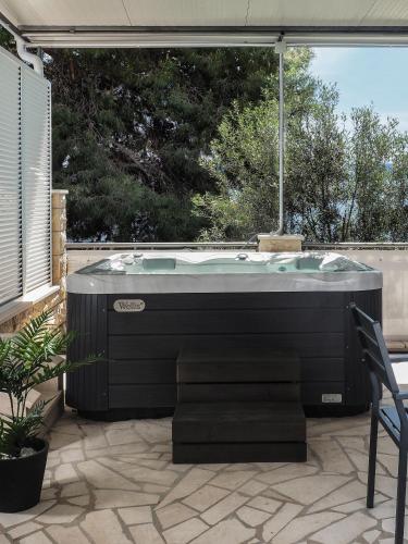 a jacuzzi tub sitting on a patio at Villa Sirenis in Trogir