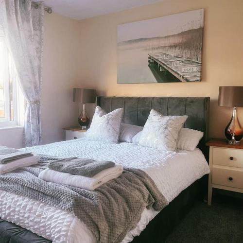 a bedroom with a bed with pillows on it at Floss Cottage in Matson