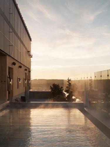a view of a building with a pool of water at The Wood Hotel by Elite in Skellefteå