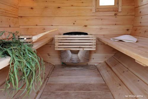 an inside view of a wooden sauna in a log cabin at בקתה בתמרים in Moshav Ramot