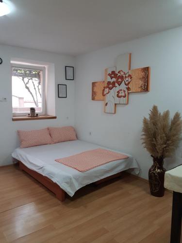 a bedroom with a bed in a white room at Karla Babić in Senj