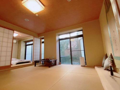 a living room with a large window and a table at WASEIDOU ZEN - Vacation STAY 17260v in Kobe