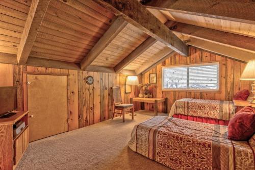 a log cabin bedroom with two beds and a television at Killdeer - Unit 6 in Sunriver