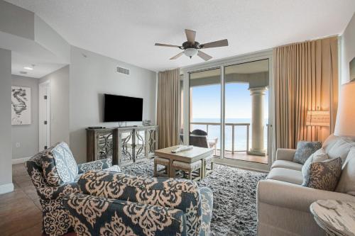 a living room with a couch and a tv at Portofino Island Resort & Spa 1-1402 in Pensacola Beach