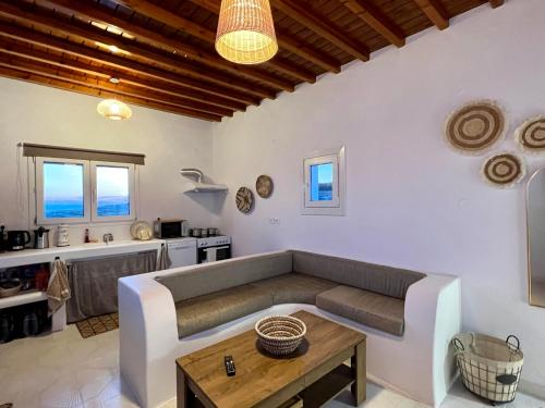 a living room with a couch and a table at Lux Mykonos house in Agios Stefanos