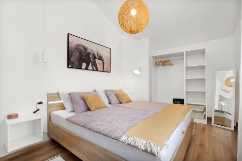 a bedroom with a bed in a white room at Villa Nola in Mali Vareški