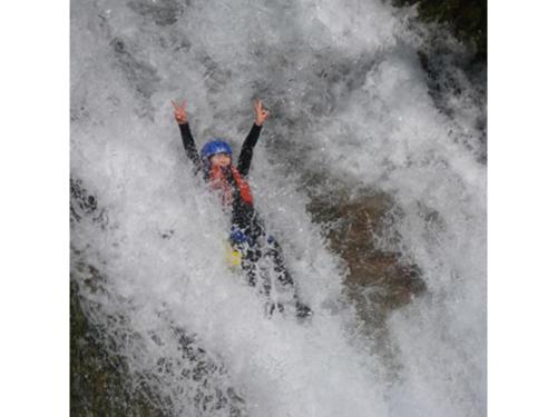 a person is riding a raft in a wave at Shimaonsen AYAMEYA Ryokan - Vacation STAY 20626v in Shima