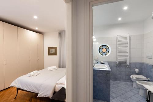 a bedroom with a bed and a sink and a toilet at Casa mia a Nervi in Genoa