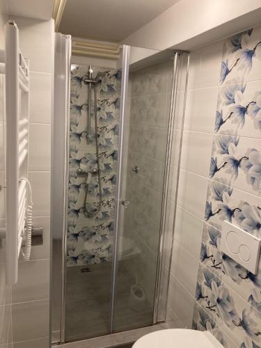 a shower with a glass door in a bathroom at Apartment Tominovic in Opatija
