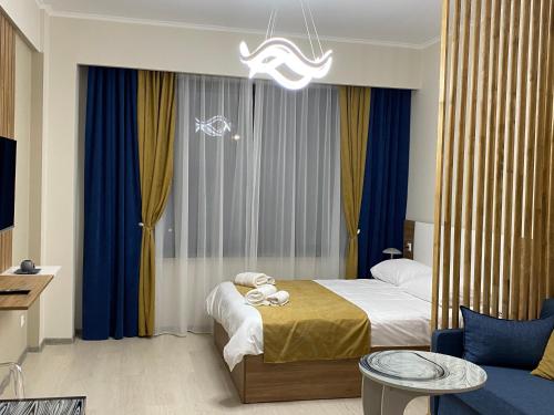 a hotel room with a bed and a chandelier at Tsaghkadzor,Alvina Complex Apartament 175 in Tsaghkadzor