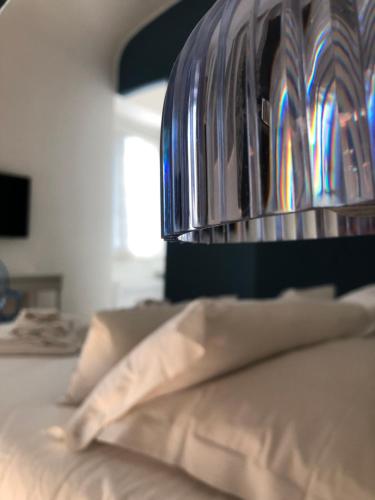 a lamp on top of a bed with a pillow at B&B Dimor'à in Pitigliano