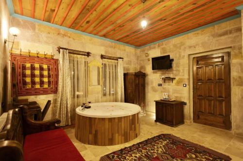 a large bathroom with a tub in a room at Travel Inn Cave Hotel in Göreme