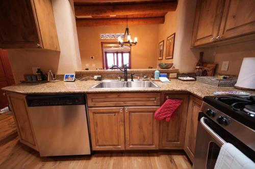 a kitchen with a sink and a stove at Magical Santa Fe Stay, Minutes From Town Square, Sleeps 4, includes free parking and outdoor hot tub! in Santa Fe