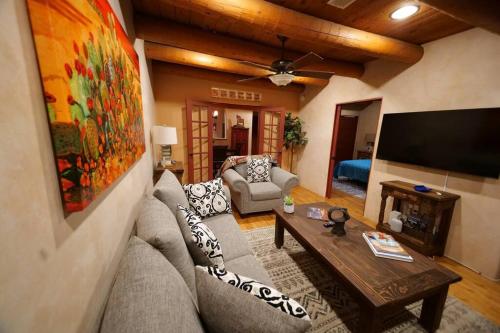 a living room with a couch and a flat screen tv at Enchanted Casita with Private Outdoor Hot Tub and Patio, Near Santa Fe Plaza, Sleeps 4 with free parking in Santa Fe
