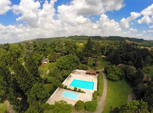 an aerial view of an estate with a swimming pool at Camping et Hotel Château du Haget in Montesquiou