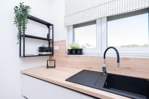 a kitchen counter with a sink and a window at Villa Balić - Podstrana in Podstrana