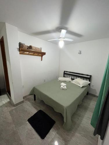 a small room with a bed and a ceiling at Pousada Luz da Lua in Búzios