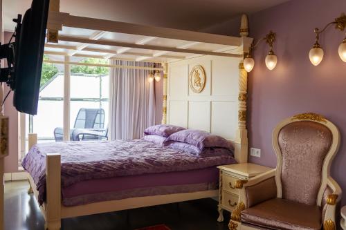 a bedroom with a bed and a window at Saint Georges Bruges Luxury Suites in Bruges