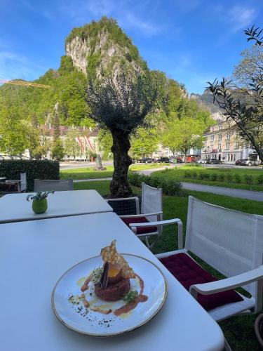 a plate of food on a table with a tree at Zimmer & Appartements am Schloßplatz in Hohenems