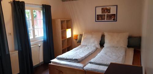 a small bedroom with a bed and a window at Ferienhaus Neumühle in Lutzerath