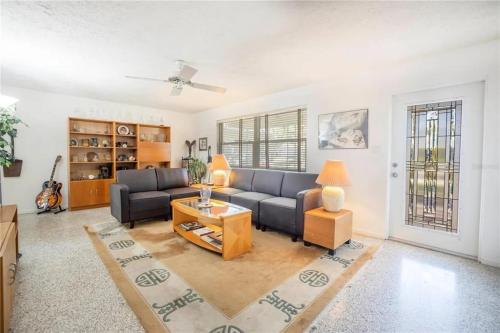 a living room with a couch and a table at Oasis on Siesta Key in Sarasota